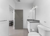 Thumbnail 28 of 61 - A white bathroom with a toilet, sink, and bathtub.