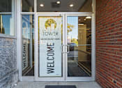 Thumbnail 52 of 61 - The entrance to a building with a glass door and a sign that says