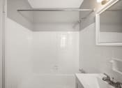 Thumbnail 21 of 48 - a white bathroom with a shower and a sink