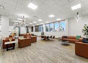 Thumbnail 36 of 61 - A modern office space with brown and orange furniture.