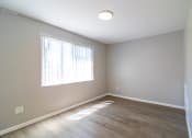 Thumbnail 2 of 19 - Renovated living room with plank flooring