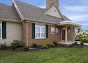 Thumbnail 1 of 13 - A house with a brown roof and a brick facade.