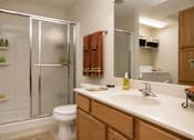 Thumbnail 12 of 13 - A bathroom with a toilet, sink, and shower.