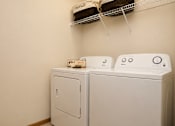 Thumbnail 13 of 13 - Two white washing machines in a laundry room.