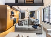 Thumbnail 21 of 40 - modern living room with a grey couch at Life At Agora, Cleveland, OH 44103  