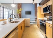 Thumbnail 19 of 40 - Kitchen with long white countertop at Life At Agora, Cleveland, OH