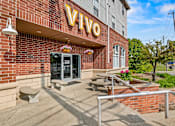 Thumbnail 12 of 19 - VIVO sign on a brick building with a bench in front. at Vivo Toledo Apartments, Toledo, 43607