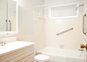 Thumbnail 20 of 31 - a white bathroom with a tub and a sink and a toilet