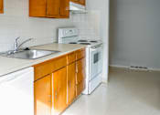 Thumbnail 3 of 31 - a kitchen with white appliances and wooden cabinets