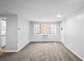 Thumbnail 3 of 35 - a spacious living room with white walls and a window