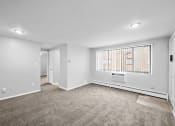 Thumbnail 4 of 35 - an empty living room with a large window and carpet