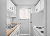 Thumbnail 6 of 35 - a white kitchen with a sink and a refrigerator