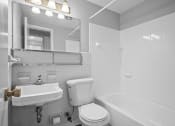 Thumbnail 14 of 35 - a bathroom with a sink toilet and a tub