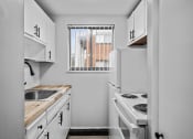 Thumbnail 22 of 35 - a kitchen with white appliances and a window