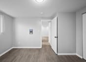 Thumbnail 25 of 35 - the living room and hallway of an empty house with white walls and wood floors