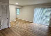 Thumbnail 4 of 18 - A room with wooden flooring and a window with blinds.