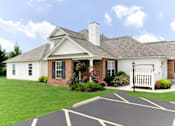 Thumbnail 1 of 27 - A white house with a black roof and a white picket fence.