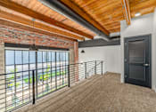 Thumbnail 10 of 40 - A room with a balcony and a black door at Life At Agora, Cleveland, OH