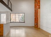 Thumbnail 13 of 40 - A room with a window and a brick wall at Life At Agora, Cleveland, OH