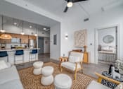 Thumbnail 3 of 40 - living room with white chair at Life At Agora, Cleveland, OH 44103