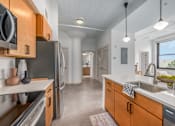 Thumbnail 2 of 40 - kitchen with wooden cabinets at Life At Agora, Ohio, 44103