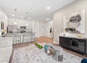Thumbnail 5 of 58 - A modern kitchen with a white sofa and a grey rug. at The Lumos Apartments, Ohio