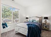 Thumbnail 13 of 58 - A bedroom with a large bed and a window overlooking a street. at The Lumos Apartments, Ohio