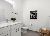 Thumbnail 14 of 58 - A bathroom with a white counter top and a toilet at The Lumos Apartments, Cleveland 44106
