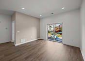 Thumbnail 29 of 58 - A room with a wooden floor and a picture of a house on the wall. at The Lumos Apartments, Cleveland 44106