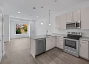 Thumbnail 19 of 58 - A kitchen with a stove, oven, and refrigerator. at The Lumos Apartments, Cleveland