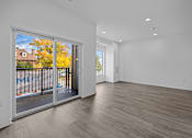 Thumbnail 23 of 58 - A room with a sliding glass door leading to a balcony. at The Lumos Apartments, Cleveland, Ohio