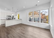Thumbnail 36 of 58 - A kitchen with white cabinets and a wooden floor. at The Lumos Apartments, Cleveland