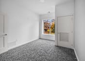 Thumbnail 38 of 58 - A room with a grey carpet and a white door. at The Lumos Apartments, Ohio