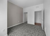 Thumbnail 39 of 58 - A room with a carpeted floor and two doors. at The Lumos Apartments, Ohio, 44106