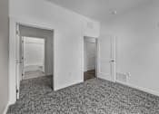 Thumbnail 43 of 58 - A room with two doors and a carpeted floor. at The Lumos Apartments, Cleveland, OH, 44106
