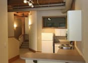 Thumbnail 8 of 11 - a kitchen with a counter top and a stove top oven
