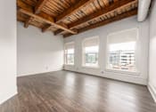 Thumbnail 4 of 11 - an empty room with white walls and a wooden ceiling