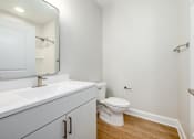 Thumbnail 32 of 44 - A white bathroom with a toilet and sink. at Park Lamont Townhomes Apartments, Cleveland, Ohio