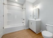 Thumbnail 30 of 44 - A white bathroom with a toilet, sink, and bathtub. at Park Lamont Townhomes Apartments, Cleveland, OH