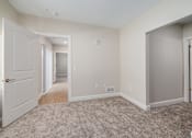 Thumbnail 28 of 44 - A room with a carpeted floor and a door on the left. at Park Lamont Townhomes Apartments, Cleveland, OH, 44106