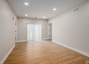 Thumbnail 27 of 44 - A large empty room with wooden floors and white walls. at Park Lamont Townhomes Apartments, Ohio