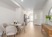 Thumbnail 4 of 44 - A modern dining room with a glass table and chairs. at Park Lamont Townhomes Apartments, Ohio