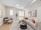 Thumbnail 5 of 44 - A living room with a couch, chair, and coffee table. at Park Lamont Townhomes Apartments, Cleveland, OH
