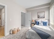 Thumbnail 9 of 44 - A bedroom with a large bed and a picture on the wall. at Park Lamont Townhomes Apartments, Cleveland, OH, 44106