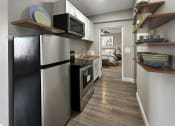 Thumbnail 8 of 48 - a kitchen with a refrigerator and a microwave
