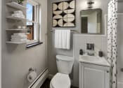 Thumbnail 13 of 48 - a bathroom with a toilet and a sink and a window