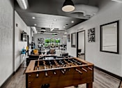 Thumbnail 11 of 19 - A room with a pool table and a foosball table. at Vivo Toledo Apartments, Toledo, OH, 43607