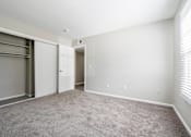 Thumbnail 7 of 18 - A room with a grey carpet and white walls.