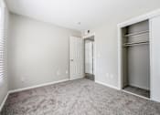 Thumbnail 6 of 18 - A room with a white door and a grey carpet.