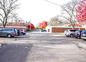 Thumbnail 20 of 20 - a parking lot filled with cars in front of a brick building
